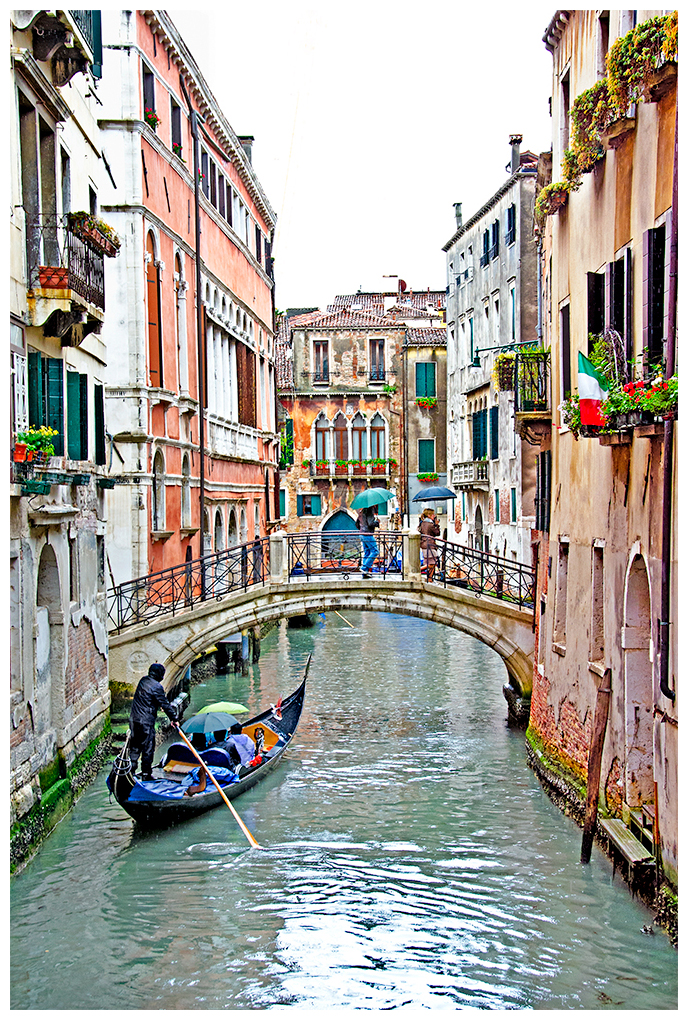 Gondoliers in Venice on a rainy day